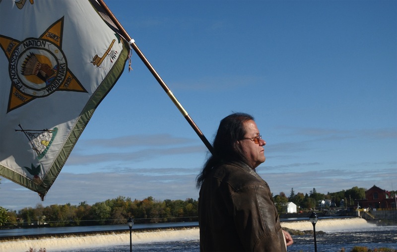 In this 2006 file photo, then-Penobscot Tribal Council member James Neptune watches an eagle fly over the Penobscot River in Orono, Maine. The federal government, saying "intervention is not a step the United States takes lightly," has asked a court to allow it to join the Penobscot Indian Nation in its lawsuit against the state over fishing and hunting rights on its ancestral river. (AP Photo/Bangor Daily News, Kevin Bennett)