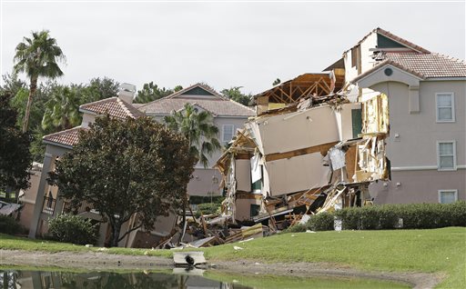 Damage to buildings caused by a sinkhole 40 to 50 in diameter is seen at the Summer Bay Resort on Monday in Clermont, Fla.