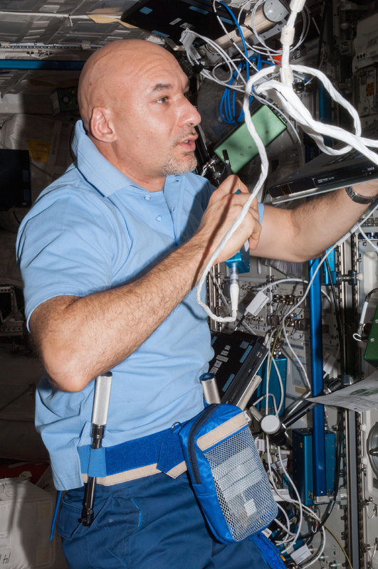 European Space Agency astronaut Luca Parmitano speaks in a microphone while working in the Columbus laboratory of the International Space Station.