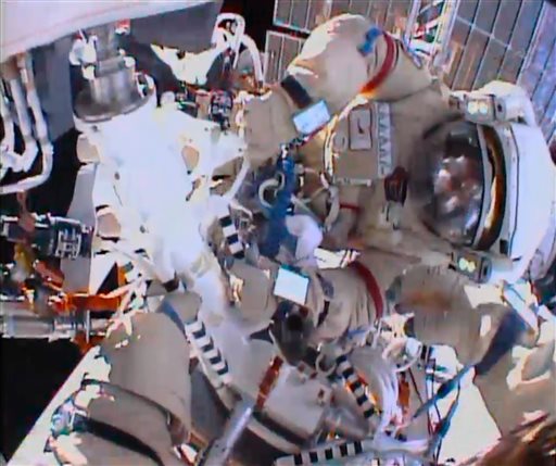 In this image from video made available by NASA, cosmonauts Fyodor Yurchikhin and Aleksandr Misurkin participate in a spacewalk outside the International Space Station on Thursday.