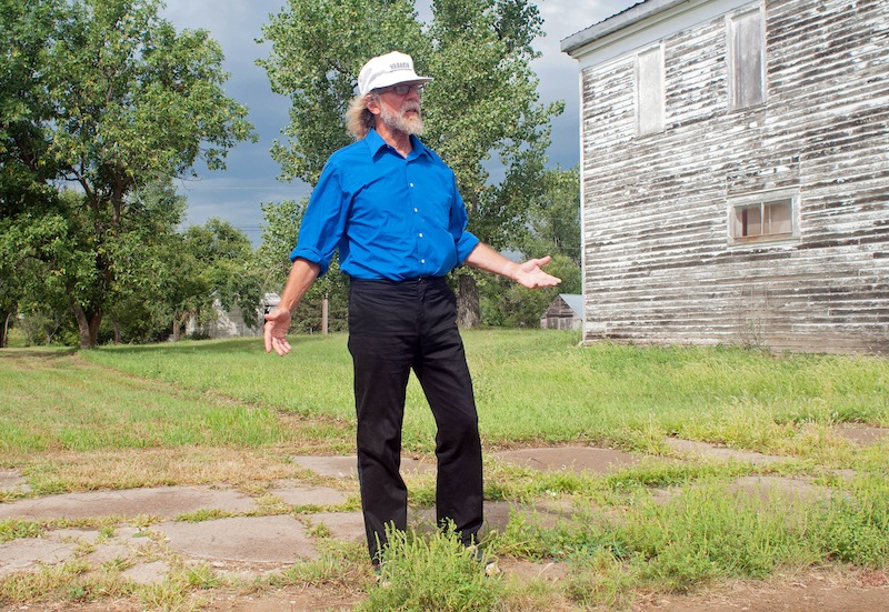 In this Aug. 26, 2013, photo Craig Cobb stands in an empty lot he owns on Main Street in Leith, N.D., where he envisions a park _ perhaps with a swimming pool _ dedicated to the late neo-Nazi and white supremacist activist William L. Pierce. Cobb, 61, a self-described white supremacist, has purchased about a dozen lots in Leith and over the past year he has invited fellow white supremacists to move there and help him to transform the town of 16 people into a white enclave. No one has come, but the community is mobilizing to fight out of fear that Cobb could succeed, and the mayor has vowed to do whatever it takes to ensure Cobb’s dream remains just that. (AP Photo/Kevin Cederstrom)