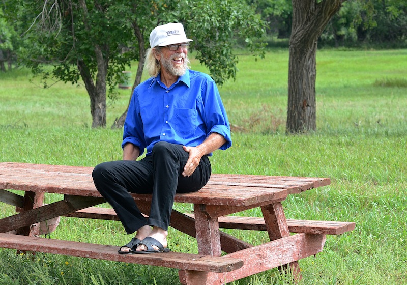 In this Aug. 26, 2013, photo Craig Cobb sits on a picnic bench in and undeveloped park in Leith, N.D., where he would someday like to hold a white power music festival. Cobb, 61, a self-described white supremacist, has purchased about a dozen lots in Leith and over the past year he has invited fellow white supremacists to move there and help him to transform the town of 16 people into a white enclave. No one has come, but the community is mobilizing to fight out of fear that Cobb could succeed, and the mayor has vowed to do whatever it takes to ensure Cobb’s dream remains just that. (AP Photo/Kevin Cederstrom)