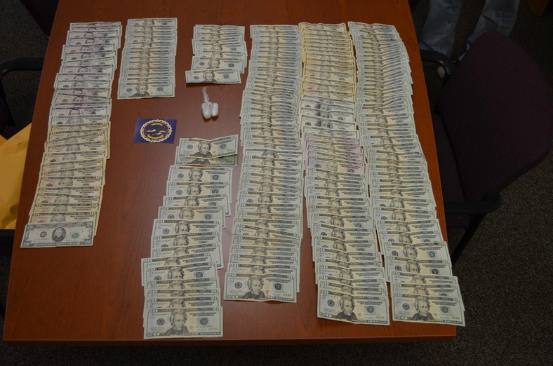 Police display cash and items found after a car chase.