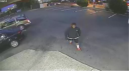 This image from surveillance video provided by the the Spokane, Wash., Police Department shows a person authorities say is a suspect in the beating death of an 88-year-old Delbert Belton outside an Eagles lodge in Spokane.