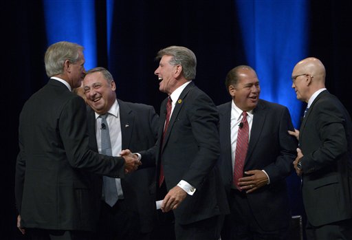 Hampton Products International Chairman and CEO H. Kim Kelley, left, Maine Gov. Paul LePage, second from left, Idaho Gov. C.L. "Butch" Otter, center, West Virginia Gov. Earl Ray Tomblin, second from right, and National Retail Federation President Matthew Shay shake hands after participating in a panel discussion at the Wal-Mart U.S. Manufacturing Summit in Orlando, Fla., Thursday.