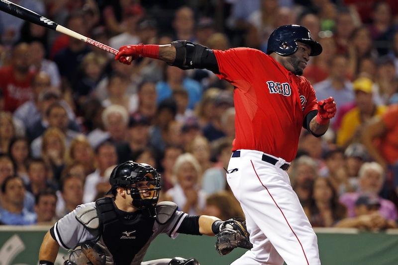Red Sox designated hitter David Ortiz hits a two-run single as White Sox catcher Josh Phegley watches during the fourth inning at Fenway Park on Friday.