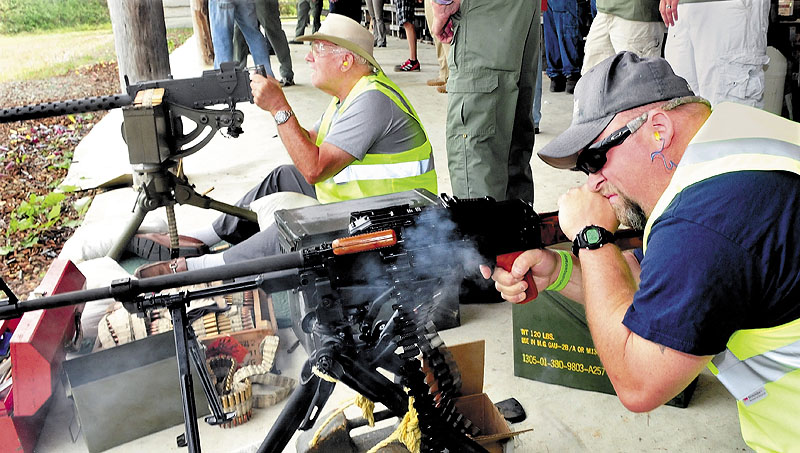 Nick Richards, right, of Winslow, fires an automatic weapon as Roland Marquis of Augusta prepares to fire his during the Wounded Warrior Machine Gun Shoot at the Williams Machine Gun Range in North Anson on Sunday.
