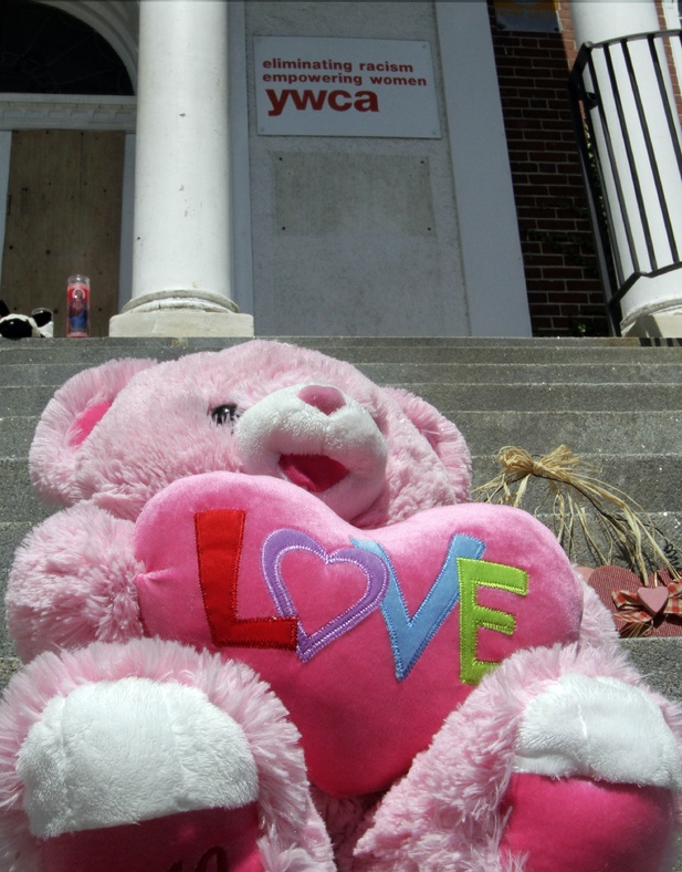 A stuffed bear sits on the steps of the YWCA Monday in Manchester, N.H., a day after 9-year-old Joshua Savyon was shot and killed by his father, who then killed himself.