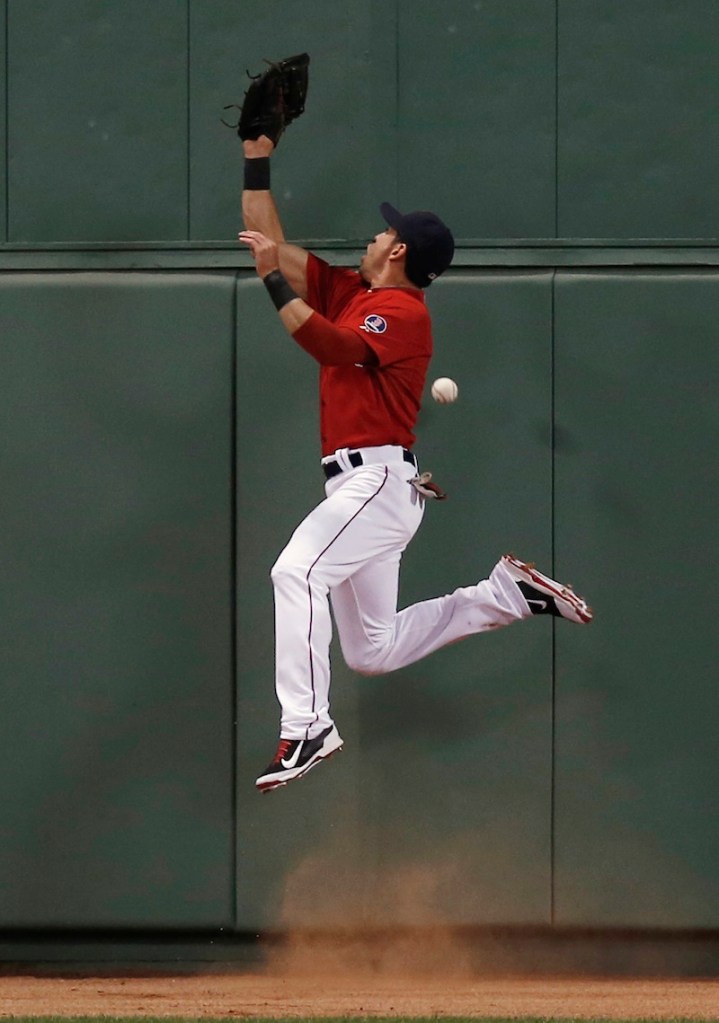 Boston center fielder Jacoby Ellsbury leaps high but can’t make the catch on what turned out to be a triple by Eduardo Nunez in the fourth inning of the Yankees’ 10-3 win.