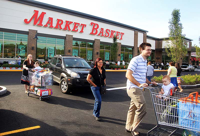 Shoppers leave Market Basket as it opens its first store in Maine, in Biddeford, on Sunday.
