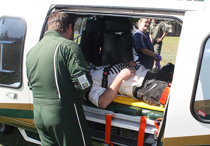 Scott Kllton, 32, of Naples, gets transported to Maine Medical Center after he was seriously injured when he was impaled by a wooden stick after being thrown from his dirt bike Sunday morning in Sebago.