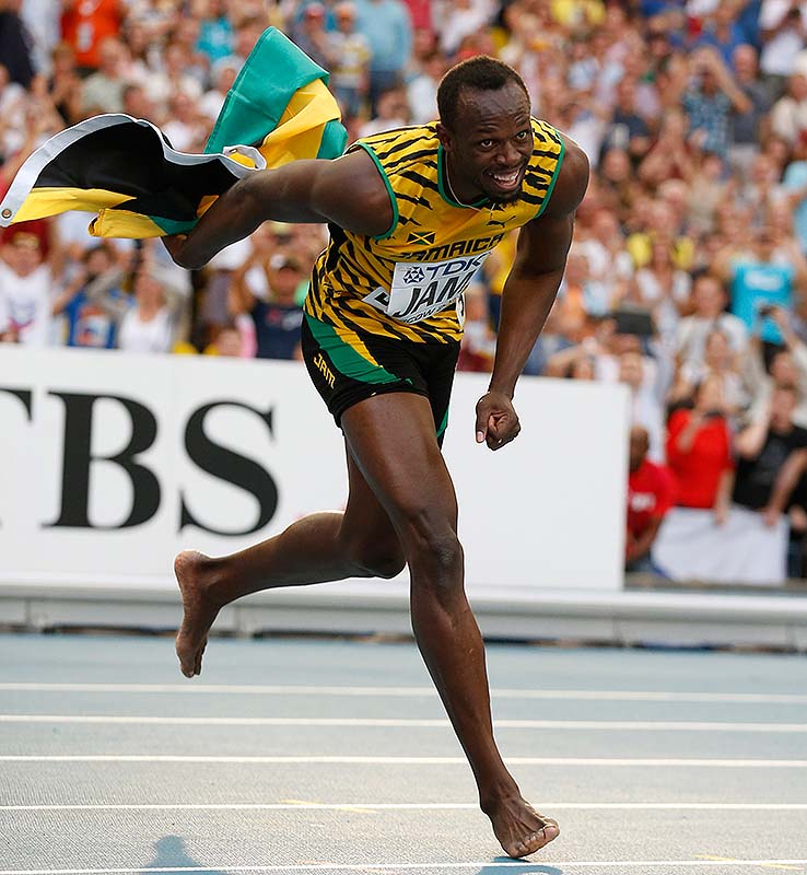 Jamaica's Usain Bolt dances after winning his third gold medal, in the men's 4x100-meter relay, at the world championships Sunday at Moscow.