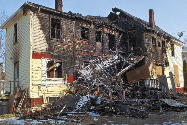 This file photo shows 146 Northern Ave. in Augusta, the morning after it was heavily damaged by a fire on March 21. The building has since been razed. Stephen Cormier, charged with two counts of arson related to the fire, is unfit to stand trial, a judge ruled today.