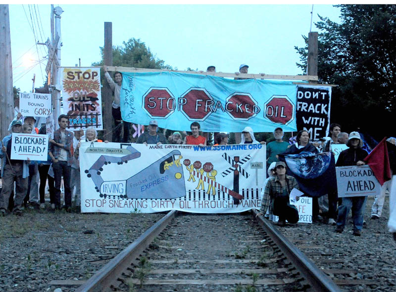 Protesters from 350 Maine and Earth First, block the railroad track crossing at Lawrence Avenue in Fairfield in June to protest the transport of tracked oil on railroads.