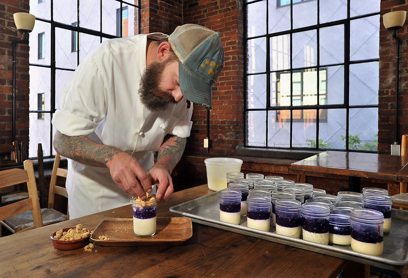 Fore Street pastry chef Brant Dadaleares assembles a serving of his blueberry “crisp,” which features vanilla panna cotta, blueberry compote, almond crisp topping and a scoop of sweet corn ice cream.