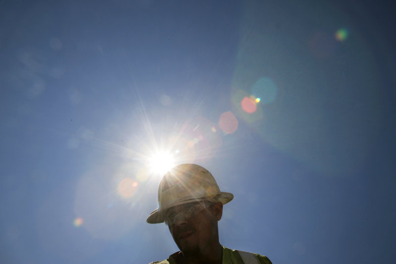 A construction worker endures the heat in San Jose, Calif., as temperatures surge during a heat wave. A massive new study finds that aggressive acts become more likely with each added degree.