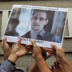 Protesters supporting Snowden hold a photo of him during a demonstration outside the U.S. Consulate in Hong Kong