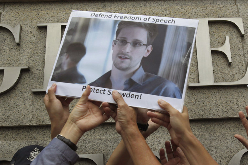 Supporters hold up a poster of Edward Snowden during a demonstration in Hong Kong last June. The former National Security Agency contractor is considered a hero by some.