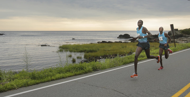 Eventual winner Micah Kogo of Kenya tucks in behind Silas Kipruto near Pond Cove between Miles 4 and 5 of the Beach to Beacon 10K. Kogo went on to beat Kipruto by five seconds.