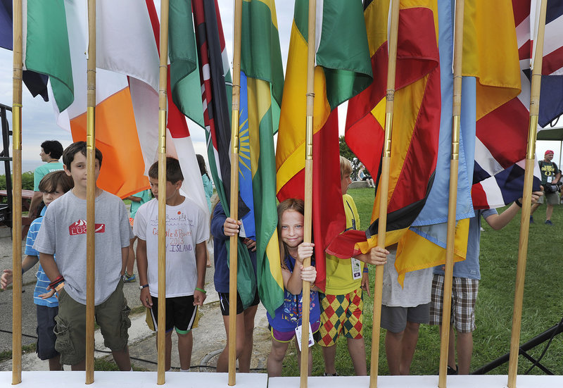 Young flag bearers await the flag parade representing the home countries of participants in the race.