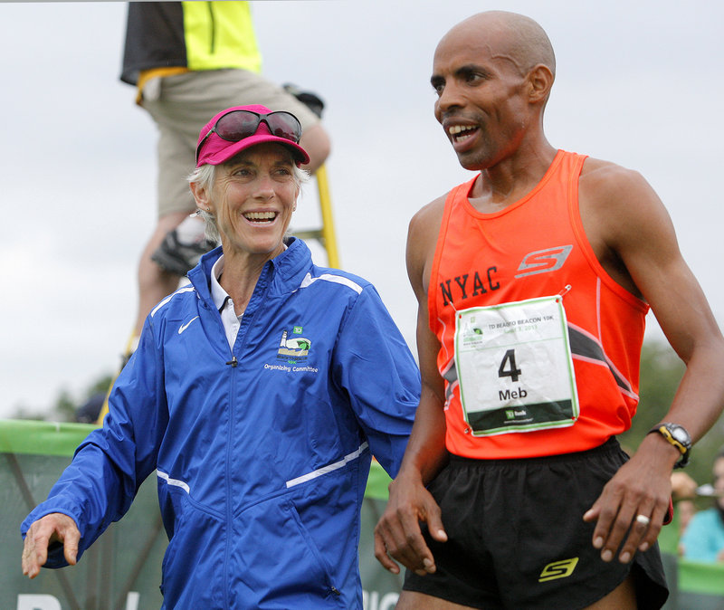 Race founder and former Olympic marathon champion Joan Benoit Samuelson talks with American elite runner Meb Keflezighi after Saturday’s race.