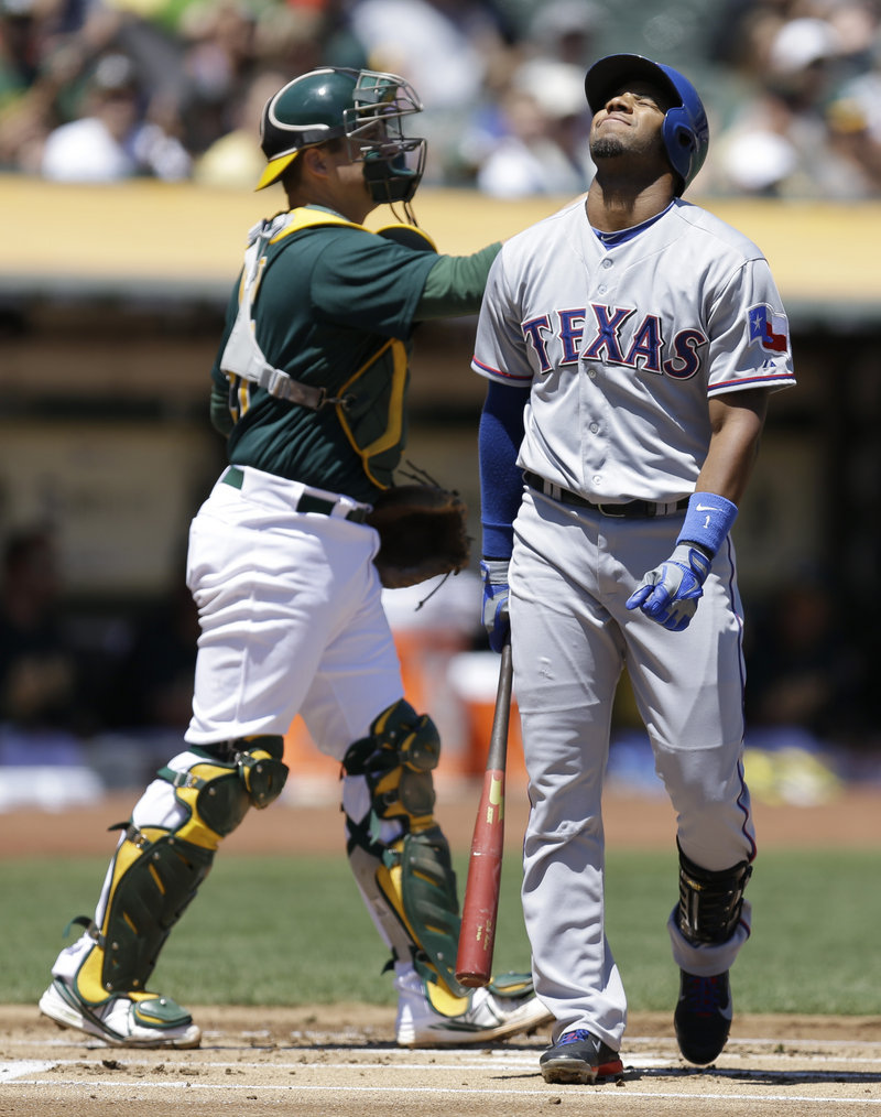 Elvis Andrus of Texas grimaces after striking out against Jarrod Parker in the first inning of a 4-2 win by the Athletics at Oakland, Calif., on Saturday.