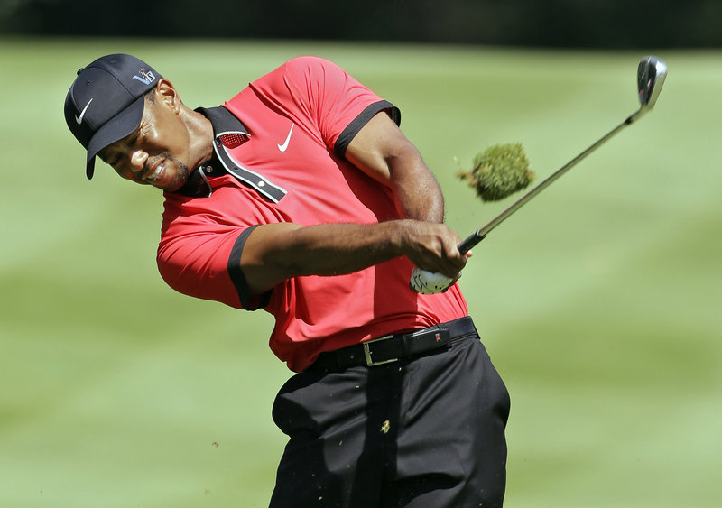 Tiger Woods hits an iron to the sixth green in the Bridgestone Invitational at Akron, Ohio on Sunday. Woods’ win was his 79th on the PGA Tour, three away from Sam Snead’s total of 82.