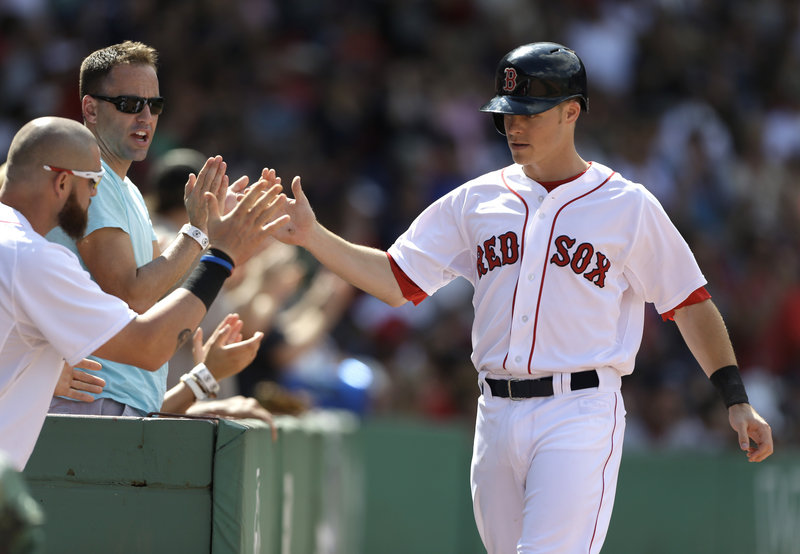 Boston’s Brock Holt gets the glad-hand treatment after scoring on a double by Dustin Pedroia in a 4-0 win over the Arizona Diamondbacksat Fenway Park on Sunday. The win was Boston’s seventh in the last nine games, including a 5-2 mark in the recent homestand.