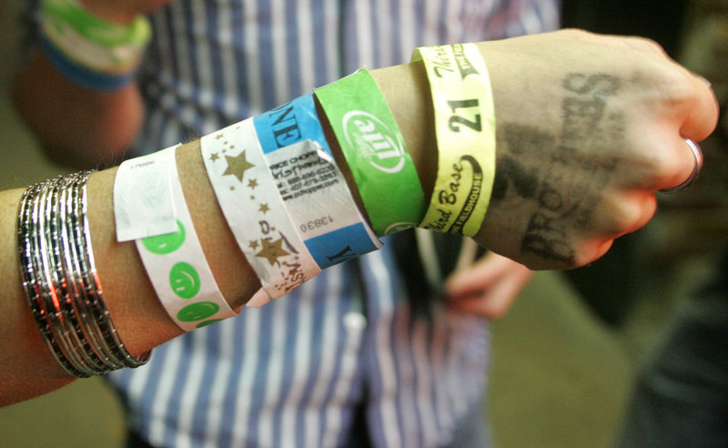 A patron shows wrist bands she collected visiting bars in downtown Iowa City. The Princeton Review named the University of Iowa the nations’s best party school.