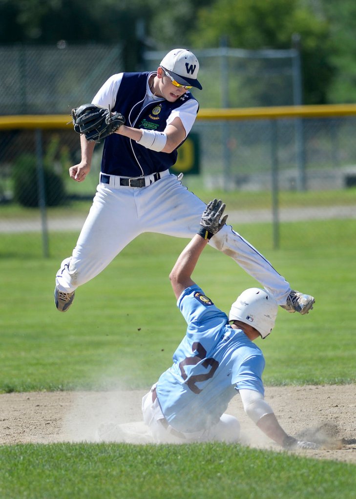 Windham’s Jack Herzig slides under the tag of Westbrook infielder Brett Goodnow during Monday’s American Legion championship game in Augusta. Windham won and advances into the Northeast Regional in Middletown, Conn.