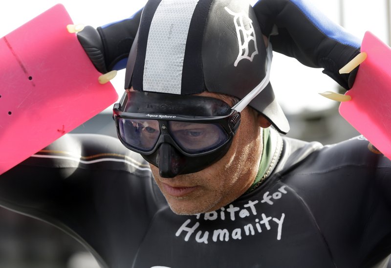 Jim Dreyer adjusts his mask before attempting a 22-mile lake crossing. The swim, to benefit Habitat for Humanity, is expected to take 30 hours and end at Detroit’s Belle Isle.