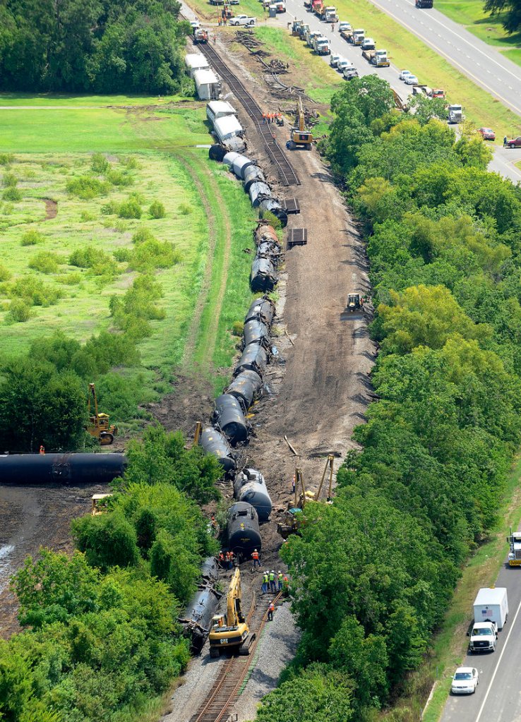 Railroad repair crews work on 1,800 feet of Union Pacific railroad track Monday after a train derailed Sunday just east of Lawtell, La.