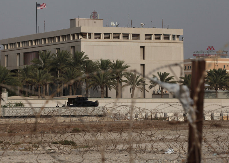 A Bahraini armored vehicle and its personnel reinforce U.S. embassy security just outside of a gate to the building, surrounded in barbed wire, in Manama, Bahrain, on Sunday, following the threat of an attack by al-Qaida.
