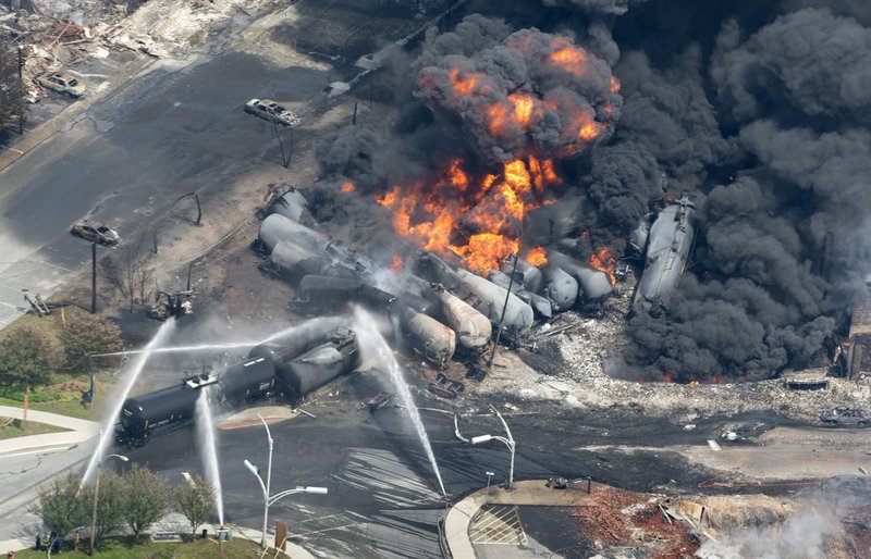 Smoke rises from railway cars that were carrying crude oil after they derailed in downtown Lac-Megantic, Quebec, on July 6. Forty-seven people were killed.