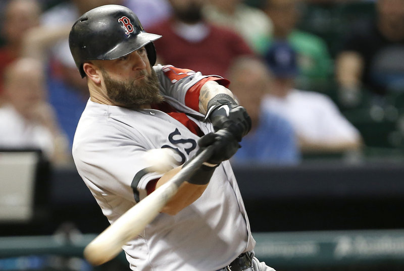 Boston’s Mike Napoli fouls off a pitch against Houston reliever Josh Fields in the eighth inning of a 2-0 win by the Astros at Houston on Monday. Napoli eventually struck out.