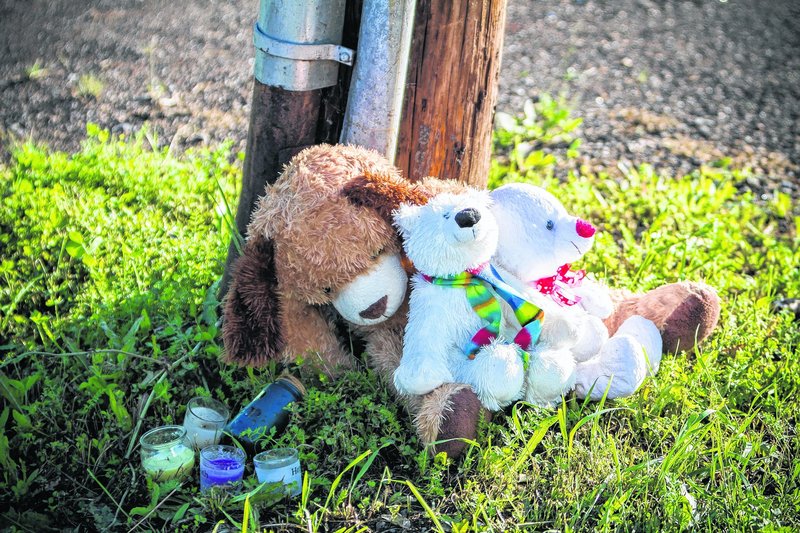 Stuffed animals and candles form a memorial outside the Reptile Ocean exotic pet store in Campbellton, New Brunswick. Two boys were killed by a python in an apartment above the store.