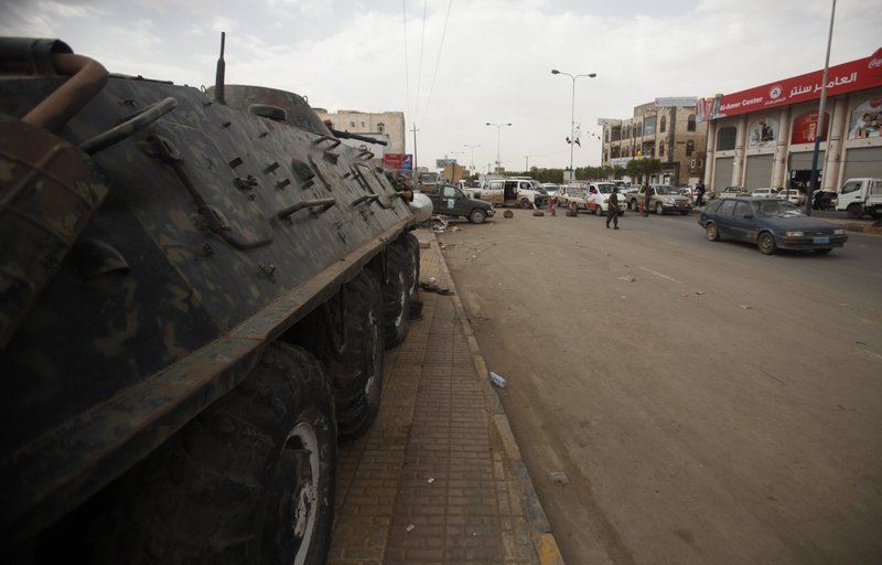 A police armored personnel carrier is stationed at a checkpoint on the road leading to the Sanaa International Airport in Yemen. The United States told its citizens in Yemen on Tuesday to leave immediately. After warnings of potential attacks, Washington shut diplomatic missions across the Middle East.