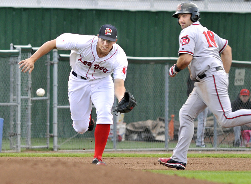 Third baseman Garin Cecchini of the Portland Sea Dogs moves in to collect a grounder in front of Tyler LaTorre of Richmond.