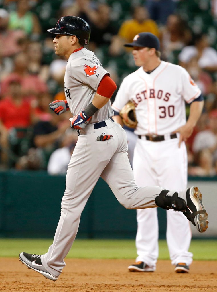 Jacoby Ellsbury of the Boston Red Sox rounds the bases in front of Houston Astros third baseman Matt Dominguez after homering.