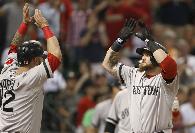 Jonny Gomes of the Boston Red Sox, right, is welcomed by Mike Napoli after hitting a three-run homer Tuesday night against Houston. Boston won 15-10.