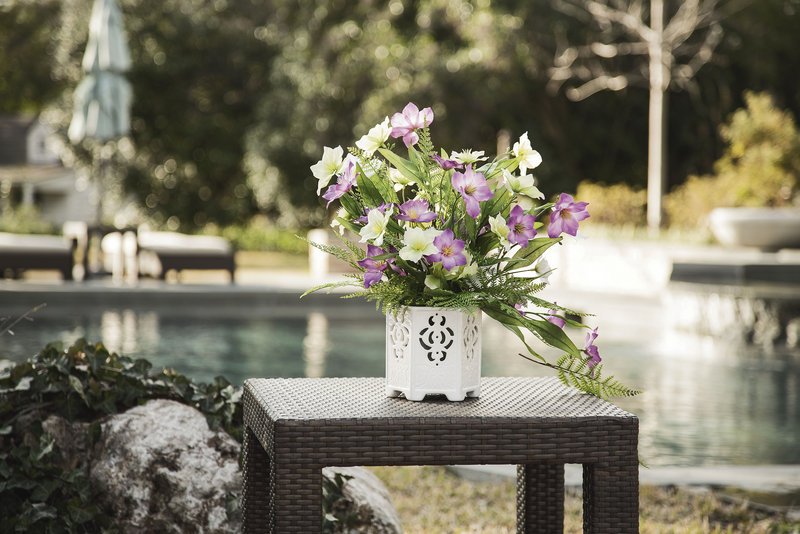 A Michaels Outdoor Vase with an artificial floral arrangement.