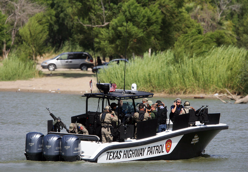 Members of Congress ride on a border security boat Tuesday in Mission, Texas. A reader urges stronger action to stop the flow of illegal immigrants to this country.