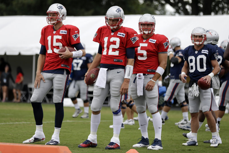 The Patriots are set at QB with Tom Brady, 12, who has backups Ryan Mallett, left, and Tim Tebow. They wait on Wednesday to run a drill during a joint workout with the Eagles in Philadelphia.