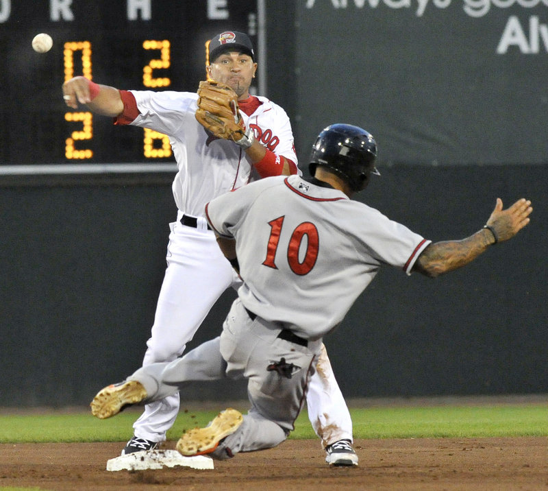 Ryan Dent throws to first to complete a double play Wednesday night after forcing Javier Herrera of the Richmond Flying Squirrels at second base. Portland fell 5-3 at Hadlock Field and is three games out of a playoff spot.