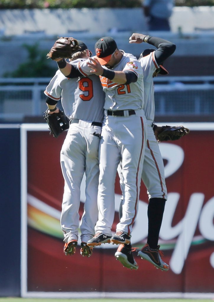 Orioles outfielders Nick Markakis, 21, Adam Jones, right, and Nate McLouth celebrate after a 10-3 victory over the San Diego Padres on Wednesday.