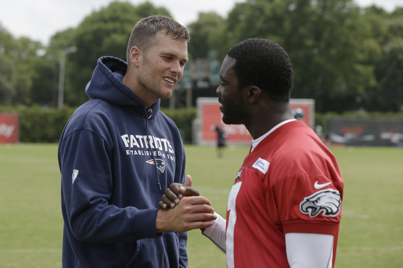 Tom Brady and Michael Vick exchange pleasantries during a joint Patriots-Eagles workout in Philadelphia prior to Friday’s exhibition game.
