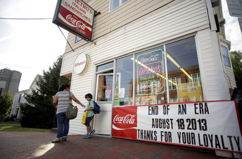 Patrons walk out of DiPietro's Italian Sandwiches on Cumberland Avenue during the dinner rush Thursday, August 8, 2013. The store will be closing its doors next Sunday, August 18, after 69 years in business.