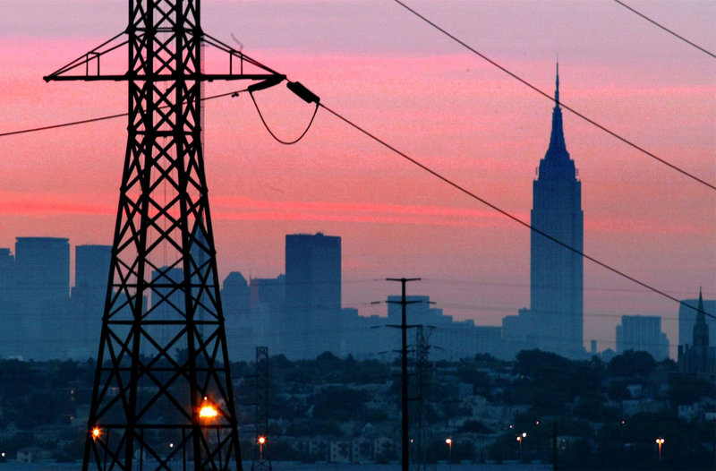 The Empire State Building towers over a darkened New York City skyline just before dawn on Aug. 15, 2003, the day after a tree branch in Ohio touched a power line and set off outages affecting 50 million people. Utilities and analysts say that changes made in the aftermath make a similar outage unlikely today, but that the U.S. electrical grid faces new stresses.