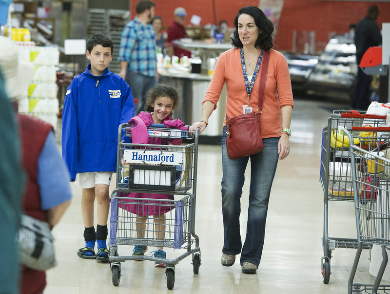 Julie Greene, manager for healthy living at Hannaford, shops with her children, Ben, 10, and Anna, 6. “If you involve (your children) in the decisions about what they want to eat,” Greene said, “they’re much more likely to eat it.”