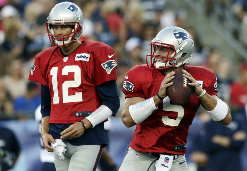 Tom Brady, left, recognizes that Tim Tebow is no threat with the New England Patriots, and is happy to give the former Heisman Trophy winner any help he can in learning the offense.